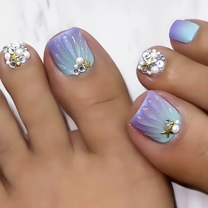 Macro detail of shell texture toe nails with purple gradient, pearls and starfish deco