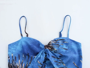 Detail of blue floral print camisole top with ruched bust and bow tie accent