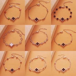 Detailed grid showing nine silver charm bracelets with clover, flower and star motifs