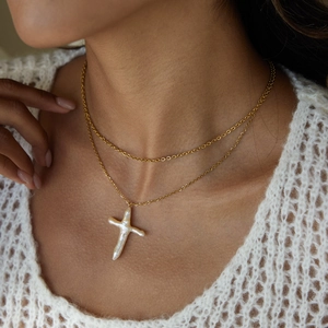 Double-layered gold titanium necklace featuring a large irregular freshwater pearl cross