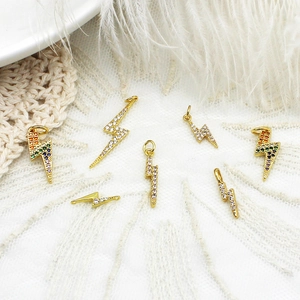 18K gold plated lightning bolt pendants with rainbow zircon on white lace and feathers
