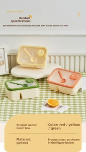Detail view of divided lunch box with utensil storage and smiley face relief design