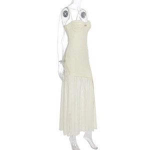 Detail of cream spaghetti strap dress featuring corset bodice and sheer mesh tiered skirt