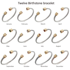 Silver twisted cable birthstone bracelets with gold accents and colorful gemstones