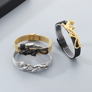 Detailed macro of stainless steel mesh bracelets with embossed leopard motifs in gold and silver
