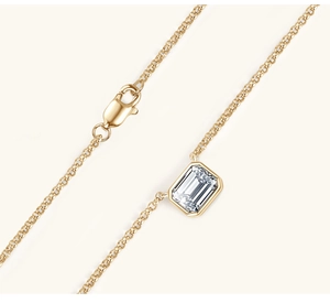Macro view of emerald-cut clear gemstone pendant on a gold S925 silver chain