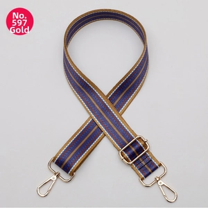 Close-up of adjustable woven purse strap with ethnic patterns and gold metal swivel hooks