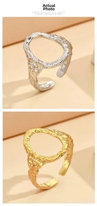 Detail view of gold and silver hammered oval open rings with textured geometric design