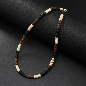 Close-up of bohemian men's turquoise coconut shell beaded necklace on dark background