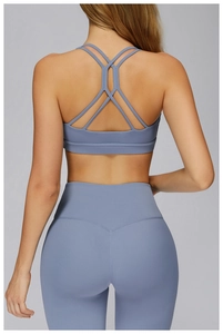 Detail of cross-back yoga bra and high-waisted leggings in soft blue-grey matte fabric