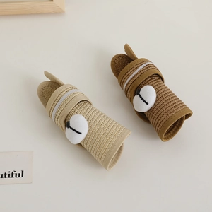 Detail of rollable straw sun hats for babies featuring cute cartoon animal ears and nose