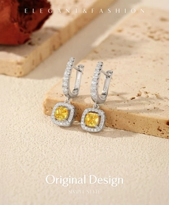 Macro detail of S925 silver hoop earrings with yellow square gemstone and tiny diamonds