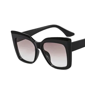 Classic black oversized cat-eye sunglasses with gradient lenses and metal hinges