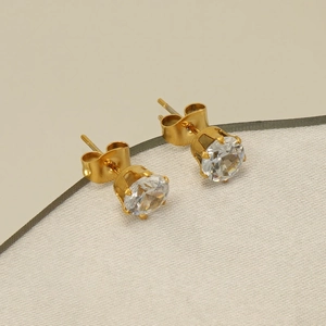 Close-up of gold-plated stainless steel stud earrings with brilliant round-cut zircon stones