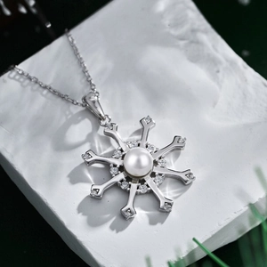 Detailed view of S925 sterling silver snowflake pendant with pearl and zircon inlay