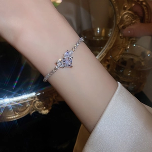 Close-up of heart-shaped crystal bracelet with silver finish on model wrist