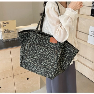 Leopard print canvas tote bag with green and black pattern and front pocket