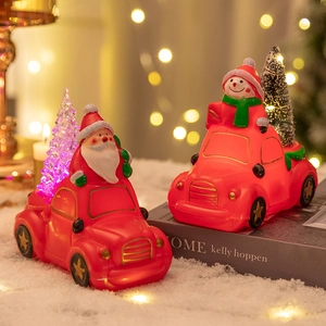 Christmas car night light with Santa and Snowman figures on snowy festive background