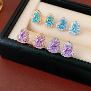 Macro shot of elegant gourd earrings with sparkling blue and purple cubic zirconia stones
