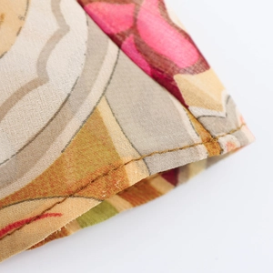 Macro detail of paisley chiffon fabric texture and high-quality yellow stitching detail
