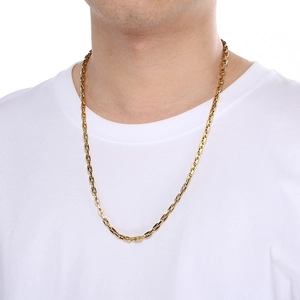 Detail of a gold pig nose chain necklace on a model showing the minimalist link texture