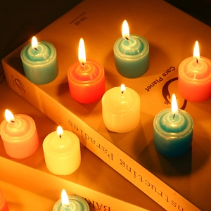Close-up of lit colorful tealight candles on vintage books for a cozy atmosphere
