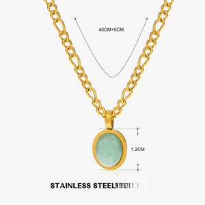Detail of gold chunky link chain with oval turquoise stone pendant in stainless steel