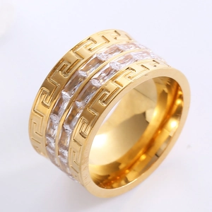 Gold wide band ring featuring Greek key pattern and double row of clear rectangular gems