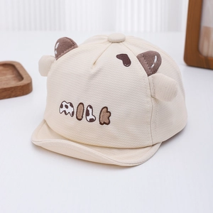 Close-up of beige baby baseball cap with soft brim and 3D ears featuring MILK embroidery