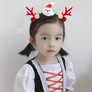 Detail of Christmas reindeer antler hair clip and plush Santa headpiece set on model