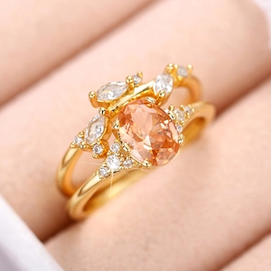 Elegant gold-plated ring set with champagne oval gemstone and leaf-shaped diamonds