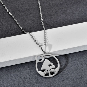 Macro shot of silver stainless steel tree pendant with wavy water pattern detail