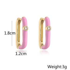 Detail view of pink enamel 18K gold earrings with size measurements 1.8cm by 1.2cm