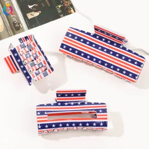 Detailed view of three large hair claws with American flag stars and stripes pattern
