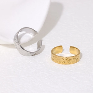 Close-up of gold and silver Horus Eye relief engravings on vintage open rings