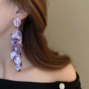Detailed view of long purple pleated petal fringe earrings with a matte texture