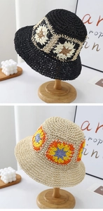 Detail of hand-woven bucket hats featuring crochet floral patterns in black and beige