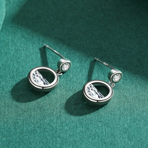 Elegant S925 sterling silver round stud earrings with sparkling zirconia on green background