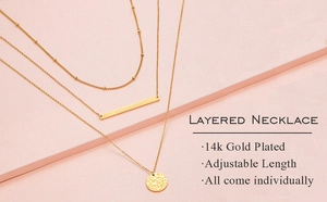 Detailed macro view of 14k gold plated layered necklaces with round and bar pendants