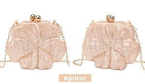 Detailed macro view of apricot flower-shaped acrylic evening bags with golden chain straps