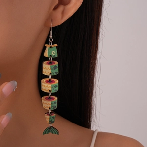 Close-up of colorful fishbone-shaped wooden earrings with creative segmented design