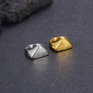 Close-up of geometric stainless steel ring showing dual polished and matte textured finish