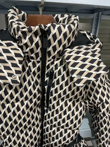 Detail of windproof stand collar and geometric diamond pattern on winter ski jacket