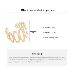 Detail view of gold metal hollow oval bangle with textured finish and dimensions