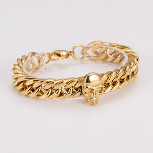 Detail showing gold stainless steel Cuban chain bracelet with 3D skull charm and lobster clasp