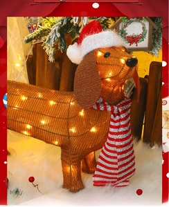 Detail view of illuminated Christmas Dachshund dog with warm LED lights and festive scarf
