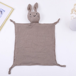 Close-up of baby muslin comforter with rabbit head design and soft knotted corners