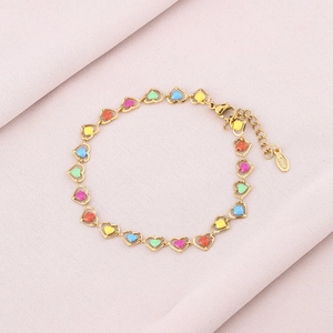 Detail of colorful enamel heart charms on a gold-plated stainless steel chain bracelet