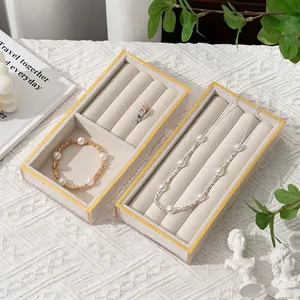 Elegant jewelry display trays with gold trim for rings, necklaces, and bracelets
