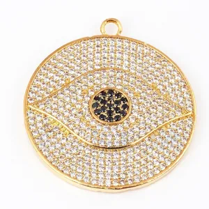 Golden Evil Eye disc pendant featuring sparkling pave set white and black crystals